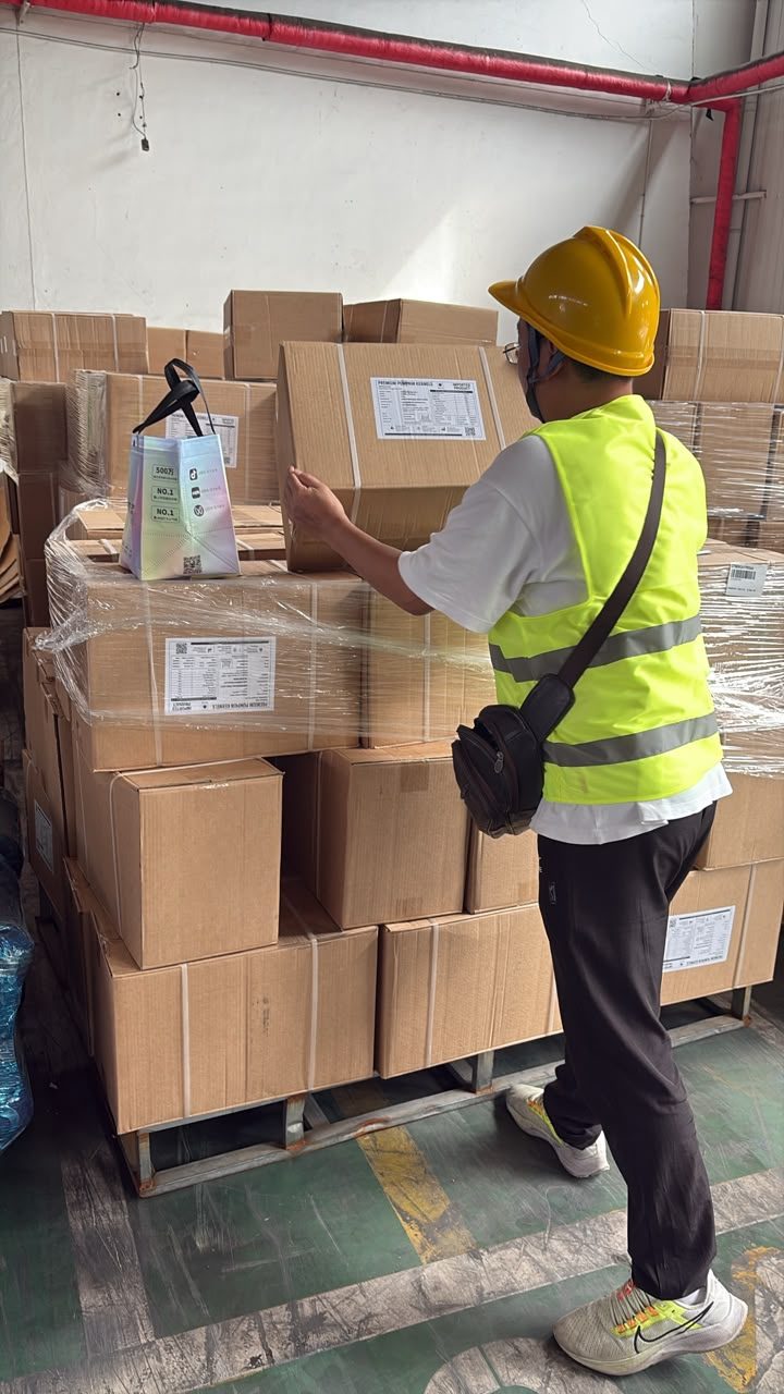 Warehouse staff checking cartons against the packing list before loading